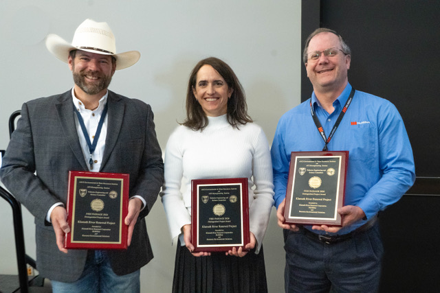 Three recipients holding the Klamath River Renewal Project award plaques